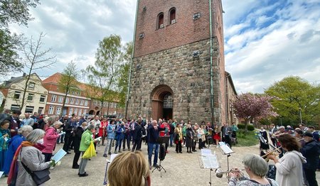 Musiker und Gemeinde vor der St. Lorenz-Kirche in Travemünde