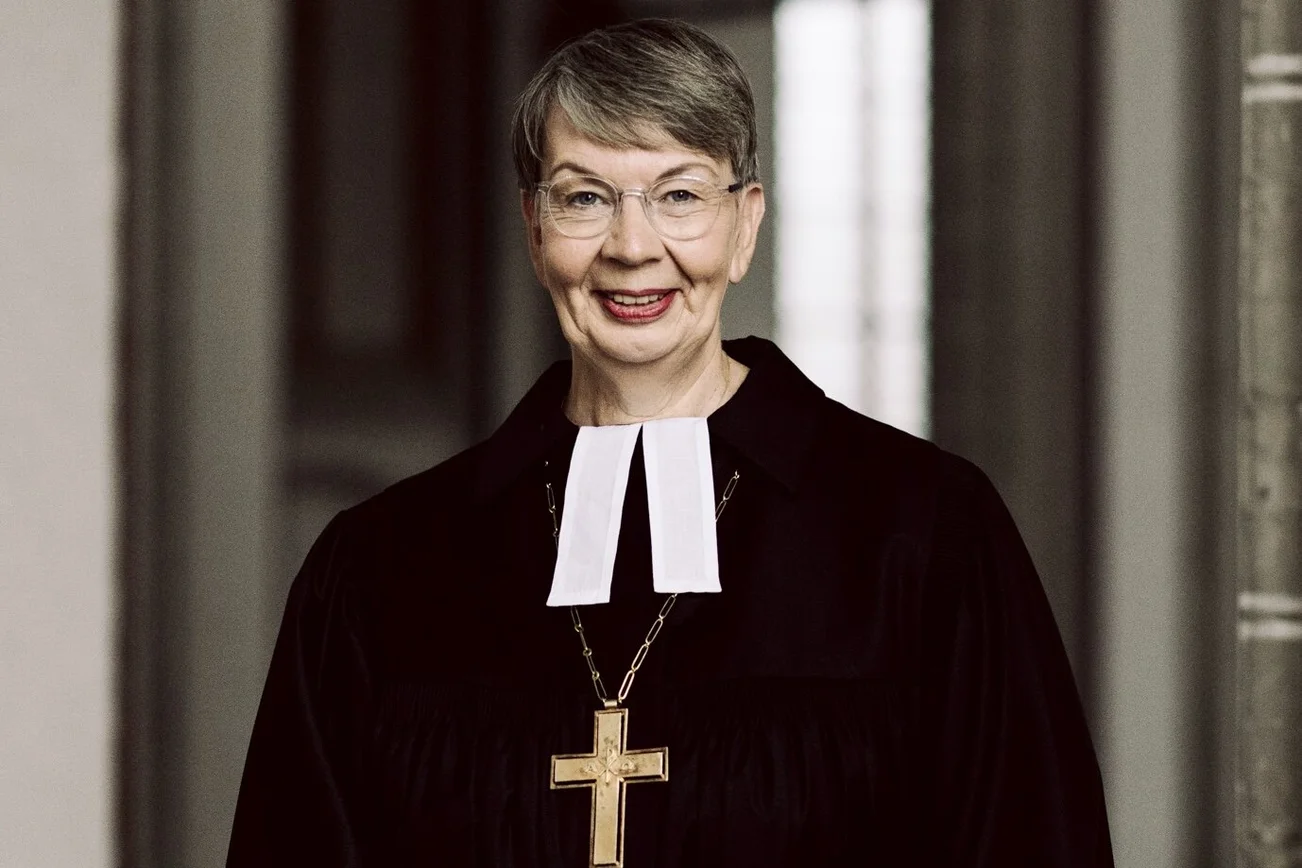 Eine Frau im Talar lächelt in die Kamera 