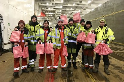 Menschen mit Weihnachtstüten auf einem Schiff - Copyright: Bärbel Reichelt