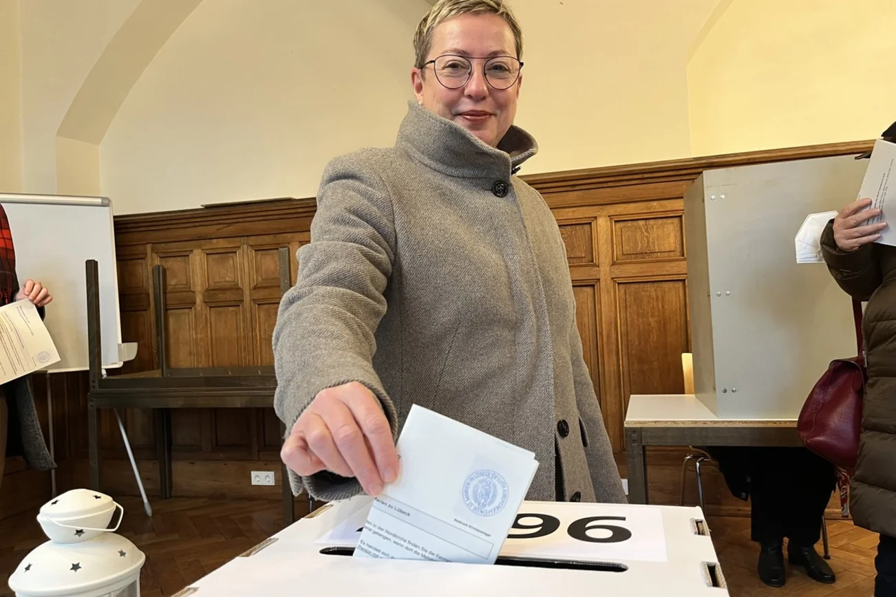 Eine Frau an einer Wahlkabine