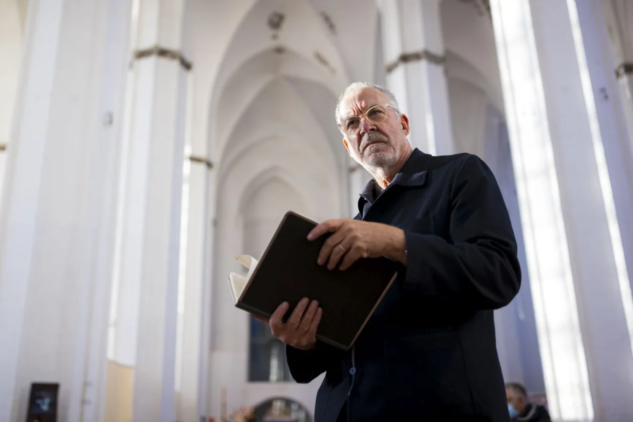 Mann in Kirche mit Buch