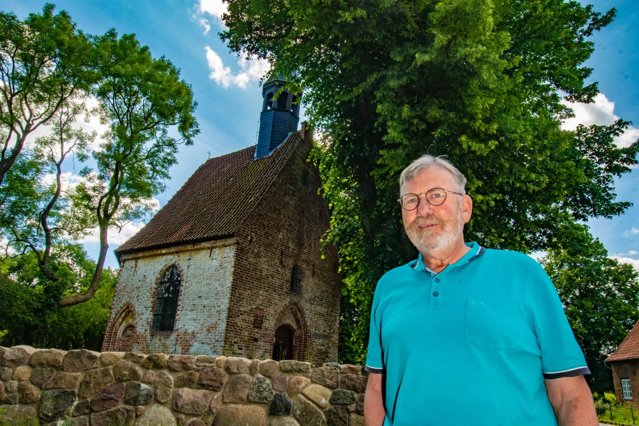 Ein Mann steht vor einer Kapelle
