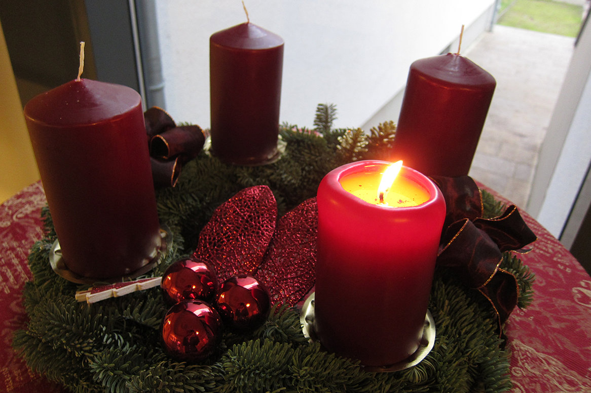 Adventskranz mit 4 Kerzen, eine Kerze leuchtet