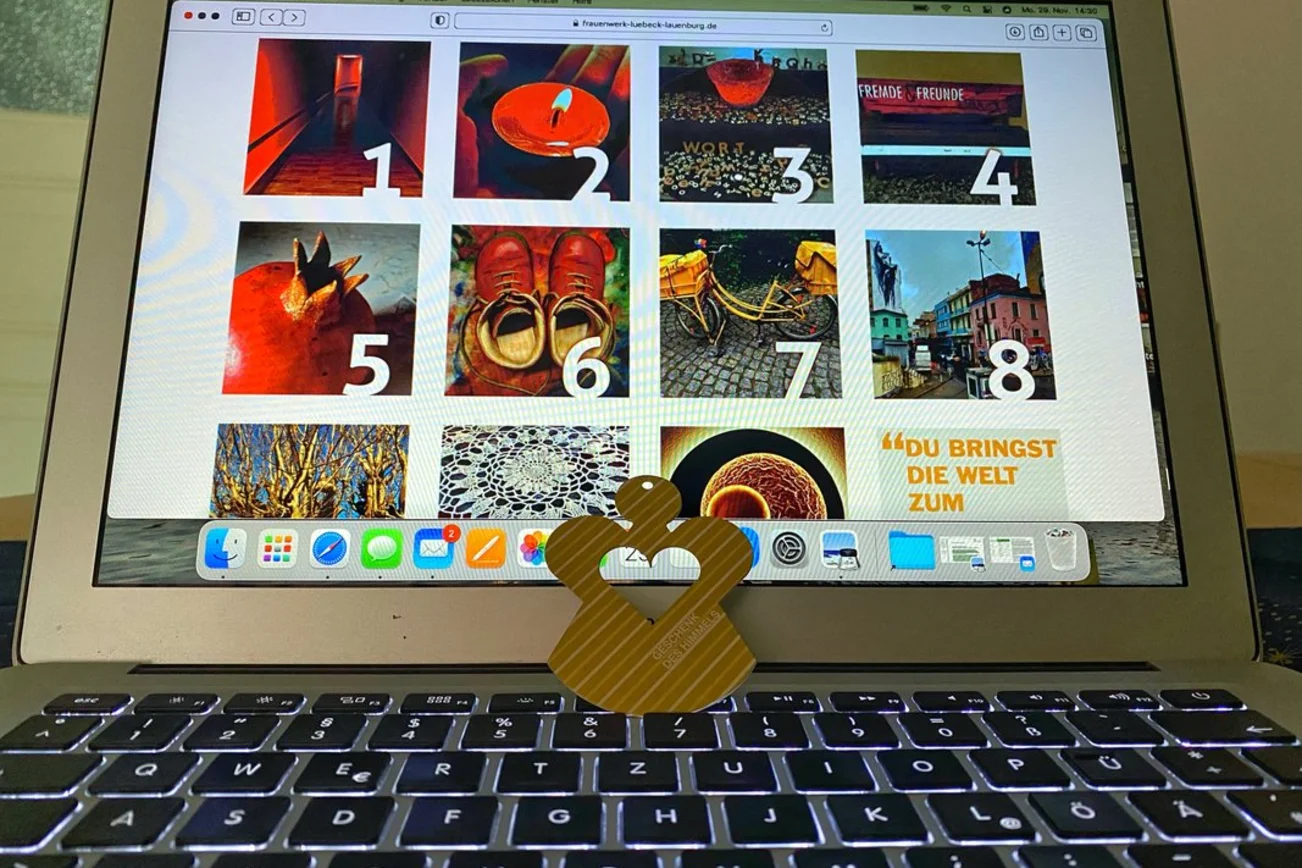 Blick auf einen Laptop, auf dessen Bildschirm ein digitaler Adventskalender zu sehen ist. 