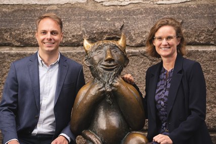 Zwei Menschen sitzen an einer Skulptur - Copyright: Oliver Beck