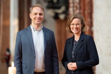 Zwei Personen lächeln in einer Kirche - Copyright: Oliver Beck