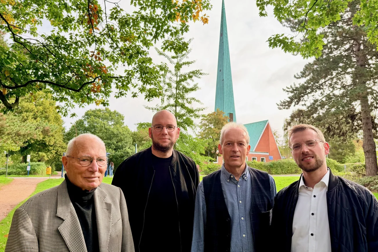 Vier Männer vor einer Kirche