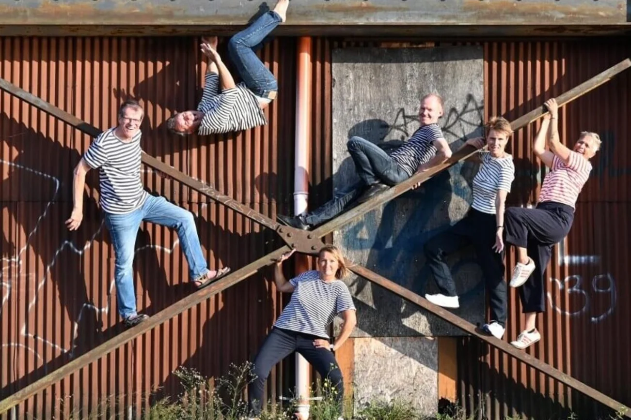 Eine Gruppe Menschen klettert auf einem Gestänge.