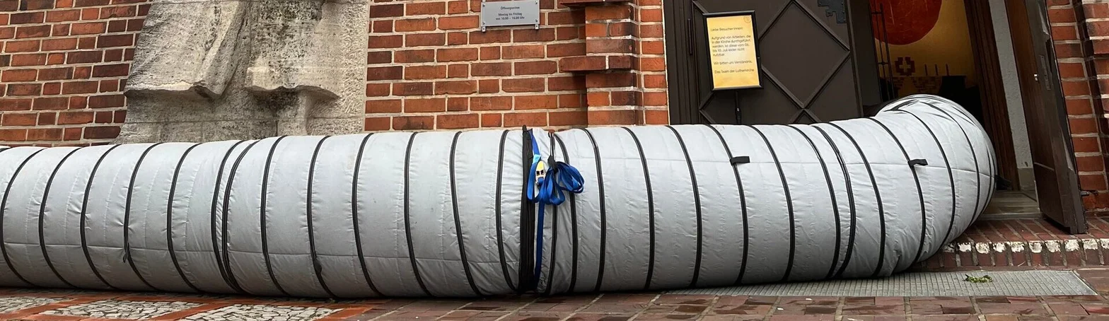 Ein großer Schlauch führt in die Kirche.