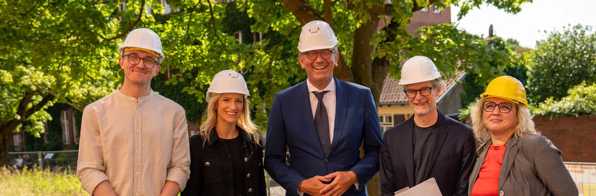 Fünf Personen mit Bauhelmen 
