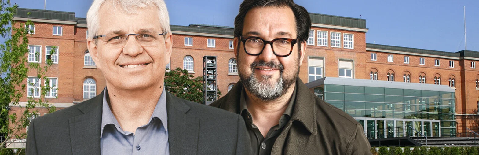 Zwei Menschen vor einem Gebäude