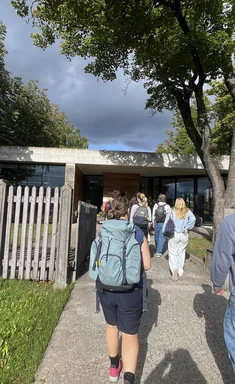 Junge Menschen gehen auf eine Gebäude zu.
